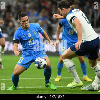 Milan, Italy. 23rd Sep, 2022. Italy's Giacomo Raspadori (L) vies with England's Harry Maguire during the League A Group 3 match at the 2022 UEFA Nations League in Milan, Italy, Sept. 23, 2022. Credit: Federico Tardito/Xinhua/Alamy Live News Stock Photo