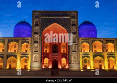 The central part of the facade of the ancient Mir-i-Arab madrasah in night illumination. Bukhara, Uzbekistan Stock Photo