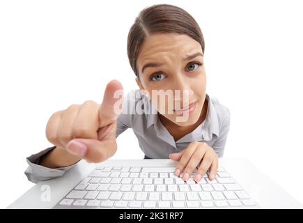 Did you press this button. Portrait of a young woman leaning against a keyboard isolated on white. Stock Photo