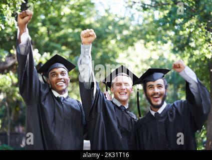 Equipped to follow their dreams. A group of happy male students celebrating their graduation day. Stock Photo