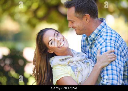 He makes me so happy. An affectionate couple outside in the summer sun. Stock Photo