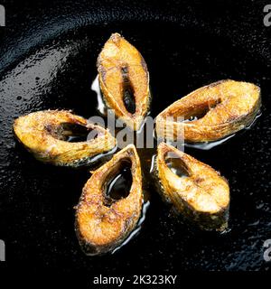 Ilsha fring on black pan. Hilsa fry is popular in pohela boishakh among Bengali's in India and Bangladesh. Stock Photo