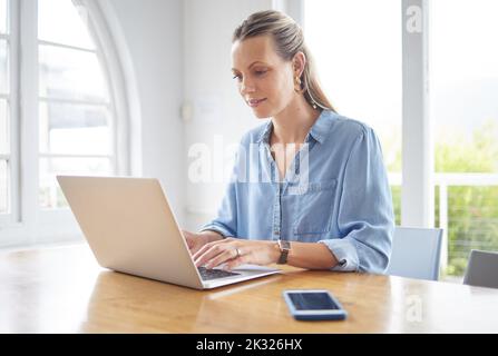 Business woman, designer and laptop in marketing office working on technology for career plan at work. Focused female employee in web design on Stock Photo