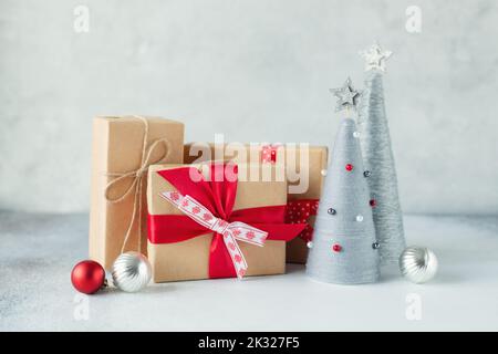 Christmas greeting card with gift boxes and yarn wrapped XMAS cone trees Stock Photo