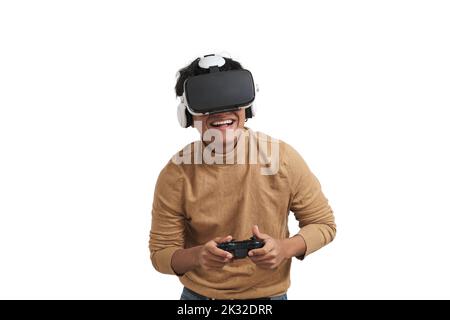 Young peruvian man playing games with joystick and vr headset, isolated. Stock Photo