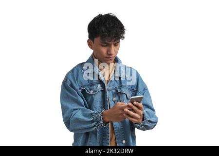 Young peruvian man using smartphone, isolated. Stock Photo
