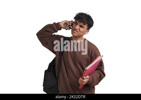 Young peruvian student talking on the smartphone confused, isolated. Stock Photo