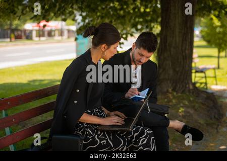 Beautiful business couple are having a nice conversation while they are working out in the city Stock Photo