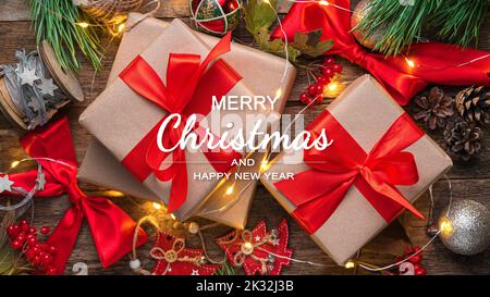 Gift boxes and Christmas tree toys on a wooden background. Stock Photo