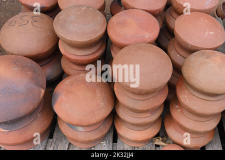 High angle view of lots of large clay pots turned upside down and stacked on top each other at a Sri Lankan road side shop Stock Photo