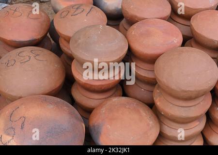High angle view of many large clay pots turned upside down and stacked one over the other. Stock Photo