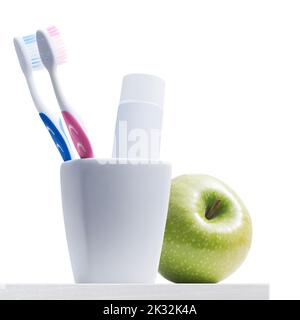 Toothbrush holder with toothbrushes and toothpaste, dental hygiene concept Isolated on white background Stock Photo