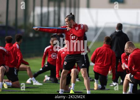 Cardiff, UK. 24th Sep, 2022. Gareth Bale of Wales jokes around pretending to do archery during the Wales football team MD1 training session at the Vale Resort, Hensol, near Cardiff on Saturday 24th September 2022. The team are preparing for their next match, a UEFA Nations league match against Poland tomorrow . this image may only be used for Editorial purposes. Editorial use only, pic by Andrew Orchard/Andrew Orchard sports photography/Alamy Live news Credit: Andrew Orchard sports photography/Alamy Live News