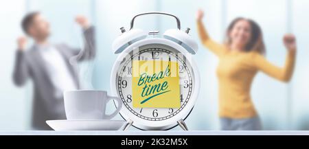 Business people taking a break in the office, alarm clock with sticky note in the foreground Stock Photo