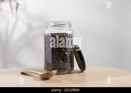 Dark roasted coffee beans in a glass jar Stock Photo