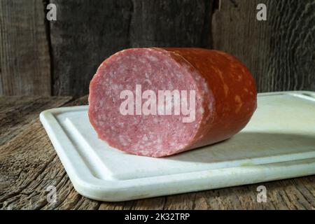 Food products on the background of old boards. Fresh sausage for breakfast. Horizontal close-up photo of food Stock Photo