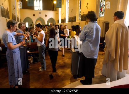 People Receiving the Sacramental Wine in Chalice at St Joseph's Church Roehampton London England Stock Photo