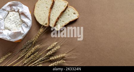Rural kitchen or bakery background with bag of flour, slices of bread and wheat spikelets. Top view Stock Photo
