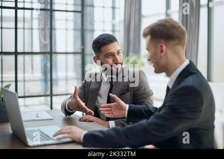 two professional businessmen discussing and using desktop computer in office Stock Photo