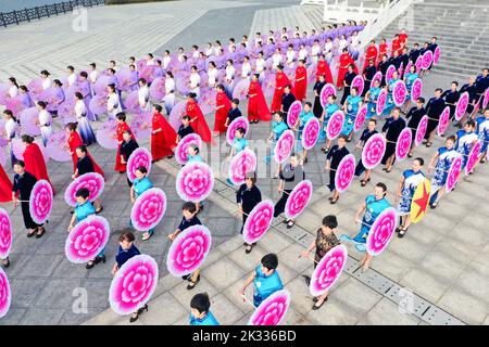 GUILIN, CHINA - SEPTEMBER 24, 2022 - Cheongsam lovers walk on the runway in front of ancient buildings in Guilin, South China's Guangxi Zhuang autonom Stock Photo