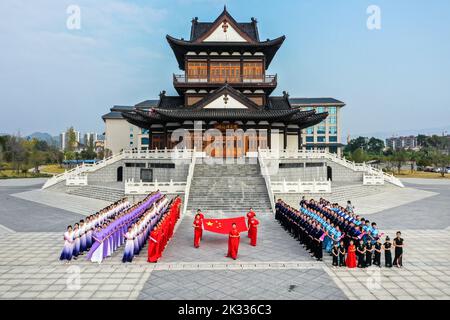 GUILIN, CHINA - SEPTEMBER 24, 2022 - Cheongsam lovers walk on the runway in front of ancient buildings in Guilin, South China's Guangxi Zhuang autonom Stock Photo