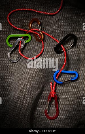 colourful carabiner accessories on a small red rope. This tool is not for climbing Stock Photo