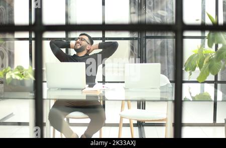 Businessman using his laptop, pc. Serious handsome bearded man worker laptop Stock Photo