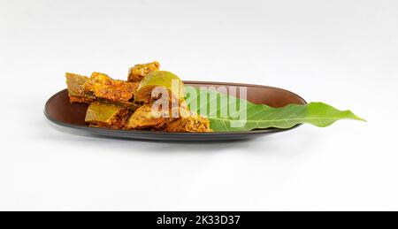 cennai mango pickle and leaf on a brown tray. Stock Photo
