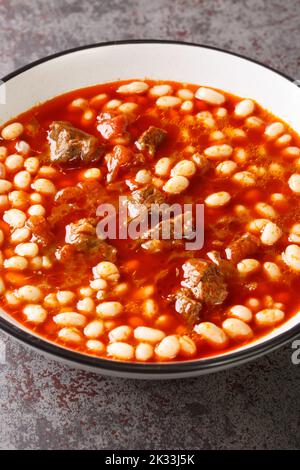Turkish White Bean Stew With Meat closeup in the plate on the table. Vertical Stock Photo