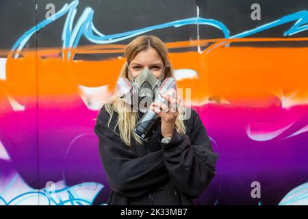 Birmingham, UK. 24th Sep, 2022. An artist of the 'RestingB Face' group, one of about a dozen women street graffiti artists working on walls in Digbeth as part of the High Vis Street Art Festival at the Tea Works. Street art of this kind is often seen as a male dominated culture, but this is changing. Credit: Peter Lopeman/Alamy Live News Stock Photo