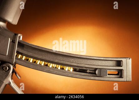 Magazine for a rimfire rifle fully loaded on a beige background Stock Photo