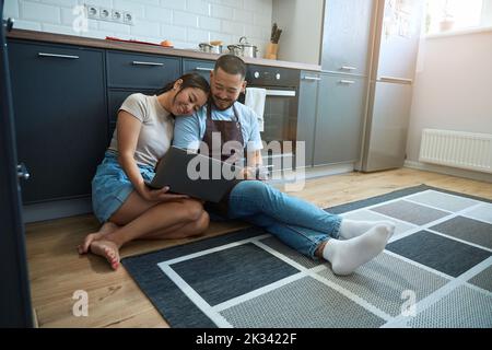 Woman and man are sitting on the floor with laptop Stock Photo