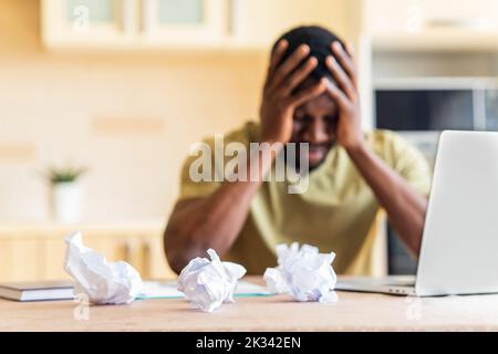 brazilian man desperate checking bills for payments in the kitchen Stock Photo