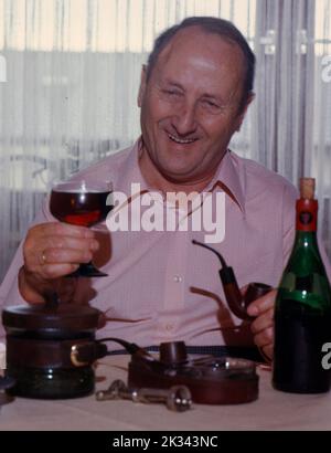 Elderly man drinking red wine Stock Photo