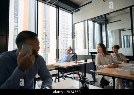 Group of four company employees working together Stock Photo