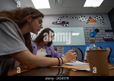 Two colleagues are focus on working papers on the table Stock Photo
