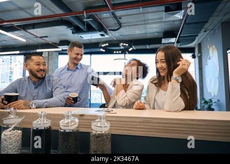 Cheerful company workers spending their coffee break together Stock Photo