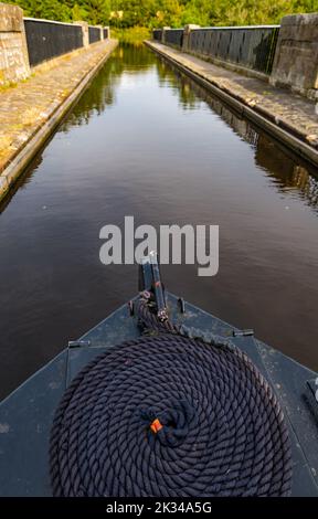 View from prow of a narrow boat barge with coiled rope on the Union Canal at Almond Aqueduct, Scotland, UK Stock Photo