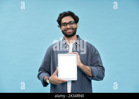 Smiling arab student showing digital tablet mockup screen presenting online ad. Stock Photo