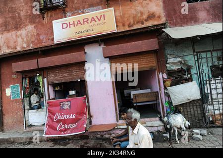 08.12.2011, Mumbai, Maharashtra, India, Asia - Street scene depicts people sitting in front of a fast food restaurant in Dharavi slum area of Mumbai. Stock Photo