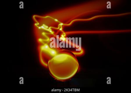 Glass ball light painting creating a comet like effect Stock Photo