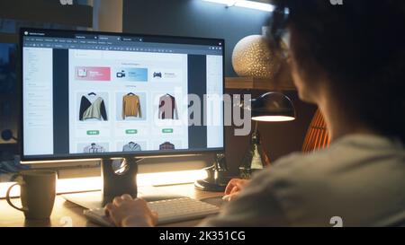 Male web designer using personal computer for creating website in professional constructor while working on project remotely at home. Freelance Stock Photo