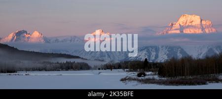 WY05074-00.....WYOMING - View of the Teton Range in winter from Oxbow Bend of the Snake River in Grand Teton National Park. Stock Photo