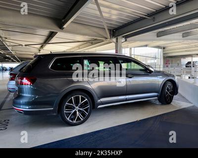 Basel, Switzerland - Sep 22, 2022: Side view of new VW electric Volkswagen Passat in large parking Stock Photo