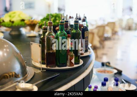 The perfect accompaniment. A collection of oilive oil and balsamic vinegar on the counter in a restuarant. Stock Photo