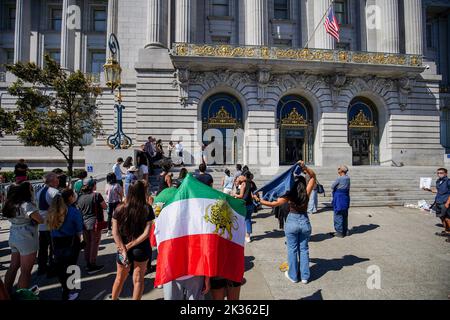 Protesters gather outside the city hall with the flag of Iran during the demonstration. After the death of the young Iranian girl Mahsa Amini, protests and demonstrations appeared in different cities of Iran. Outside Iran, protests and rallies to support people in Iran also happen across the world. In San Francisco, a few people protested outside the San Francisco City Hall. The protesters say they want to express their voice to the Iranians and let them know there are many people support them in the world. Also, there are some Iranians join the protest and speak on the protest. (Photo by Mich Stock Photo