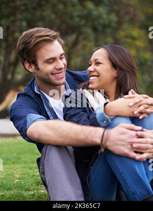 Sharing a tender moment together. a good-looking young couple enjoying an affectionate moment outdoors. Stock Photo
