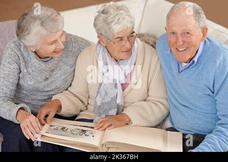 Taking a trip down memory lane. seniors looking through a photo album. Stock Photo