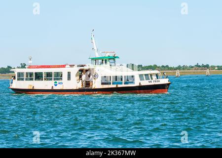 Ferry or Vaporetto with tourists in motion in the Venetian Lagoon. Venice, Veneto, Italy, Europe. Actv (municipal company for public transport). Stock Photo
