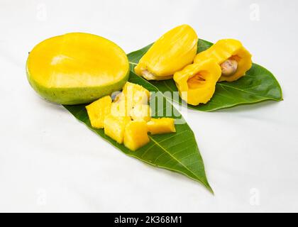 Jackfruit And Mango cut on leaves. tropical summer fruits in Asia. isolated studio photo. refreshing hot day fruit salad. Stock Photo